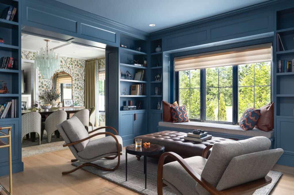 Blue home library with custom built-ins, window seat and tailored furnishings in a Glenview, Illinois home by Stojakovic Design